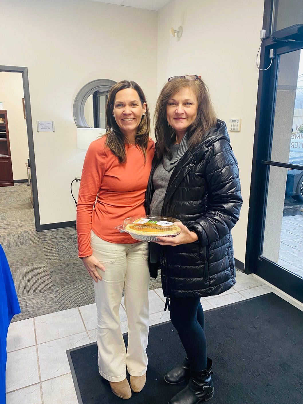 Client picking up their pie at the pumpkin pie give-away