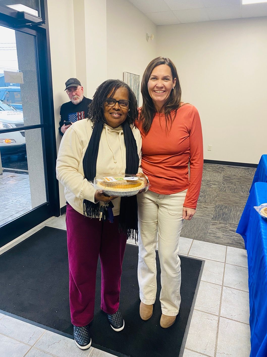 Pictures with clients holding pumpkin pies from the giveaway