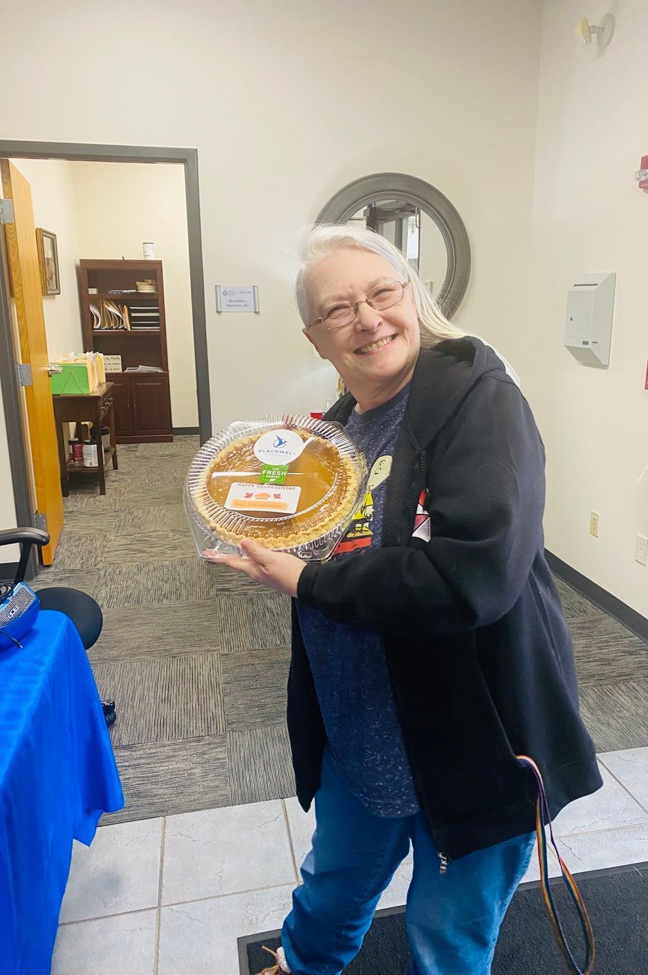 Client picking up their pie at the pumpkin pie give-away