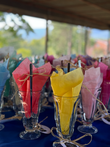 A bunch of glasses filled with tissue paper and straws