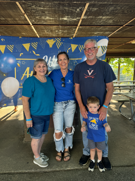 A group of people posing for a picture with one wearing a shirt that says virginia tech