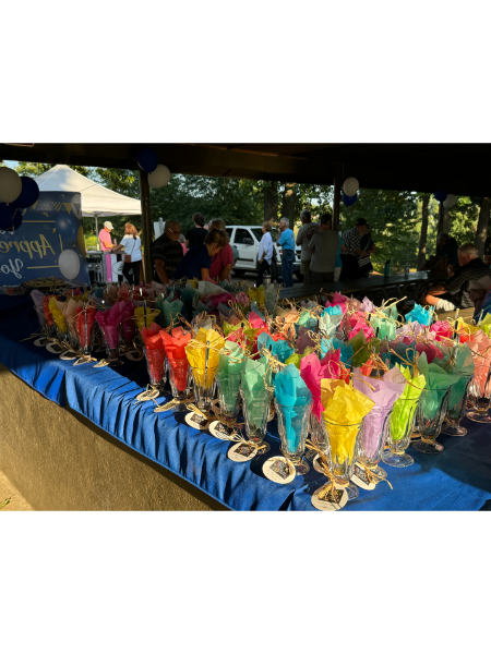A table filled with lots of colorful cups of candy.