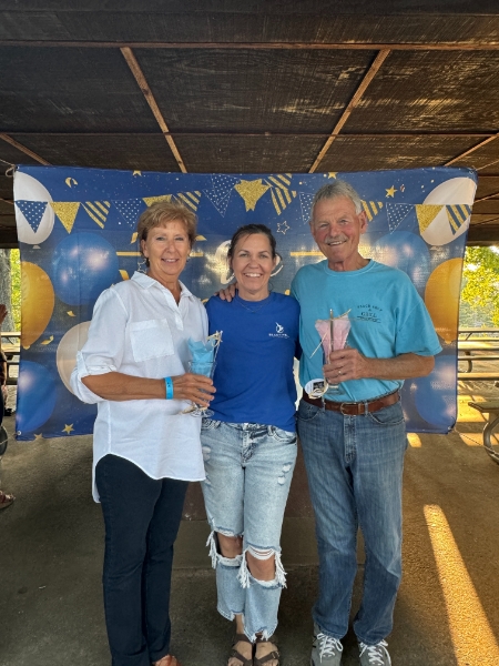 A group of people posing for a picture with cotton candy