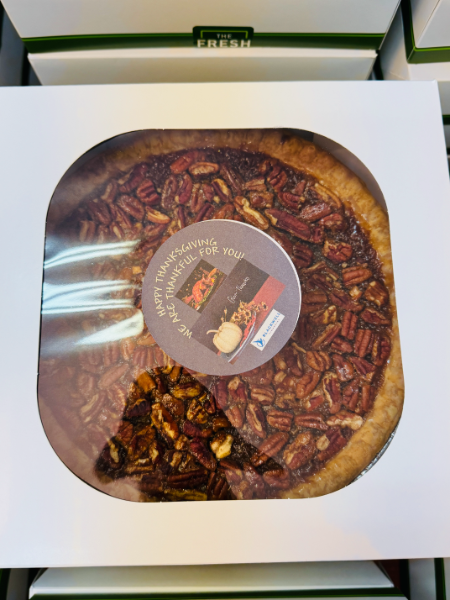A pecan pie is in a white box