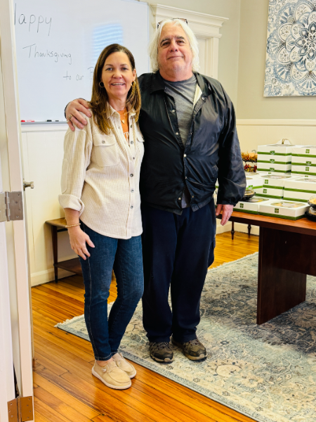 A man and a woman are standing next to each other in a room.