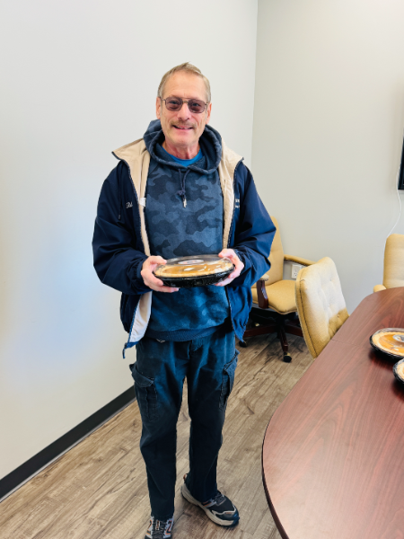 A man is holding a plate of food in his hands