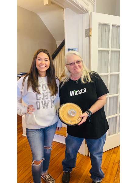 Two women standing next to each other one wearing a shirt that says wicked
