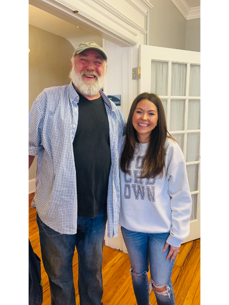 A man and a woman are posing for a picture in a room