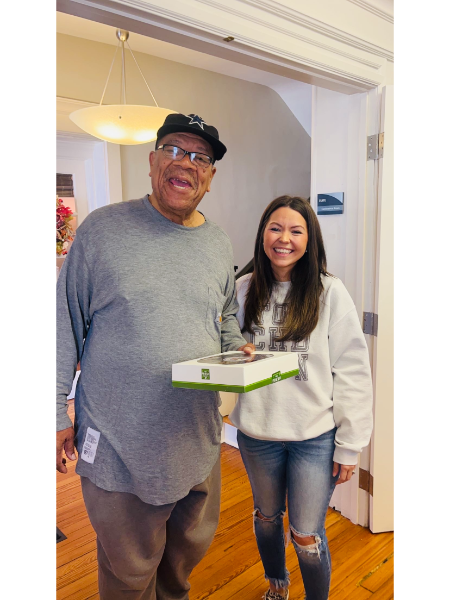A man and a woman standing next to each other holding a box