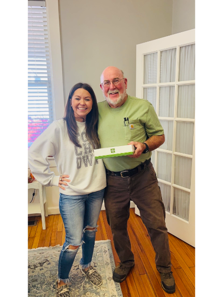 A man and a woman are standing next to each other in a living room.