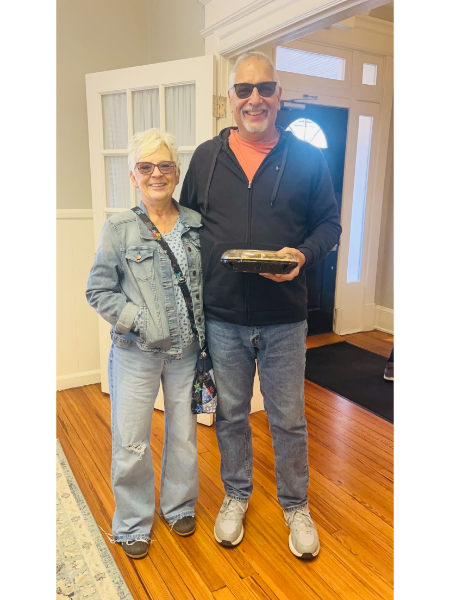 A man and a woman standing next to each other on a wooden floor
