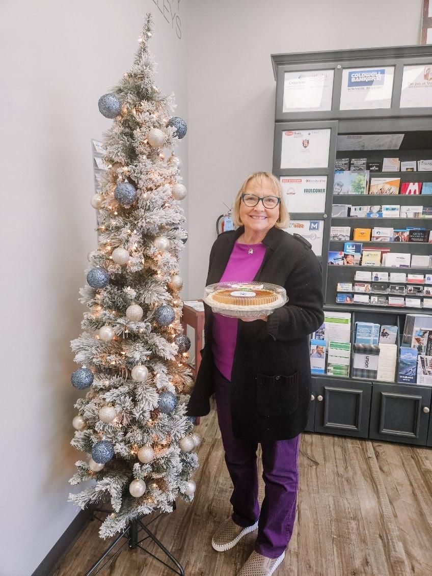 Client picking up their pie at the pumpkin pie give-away