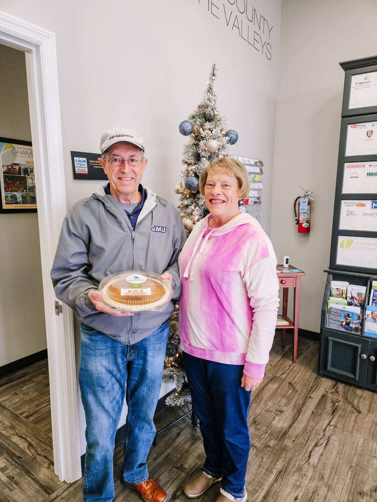 Client picking up their pie at the pumpkin pie give-away