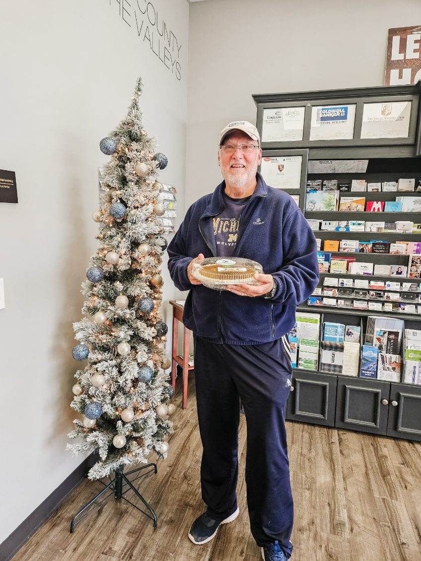 Client picking up their pie at the pumpkin pie give-away