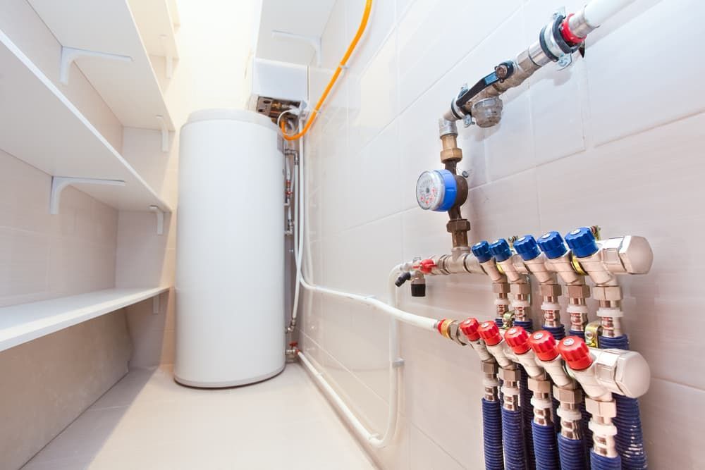 A Room with A Water Heater and A Bunch of Pipes — Blair Merlehan Plumbing in Wagga Wagga, NSW