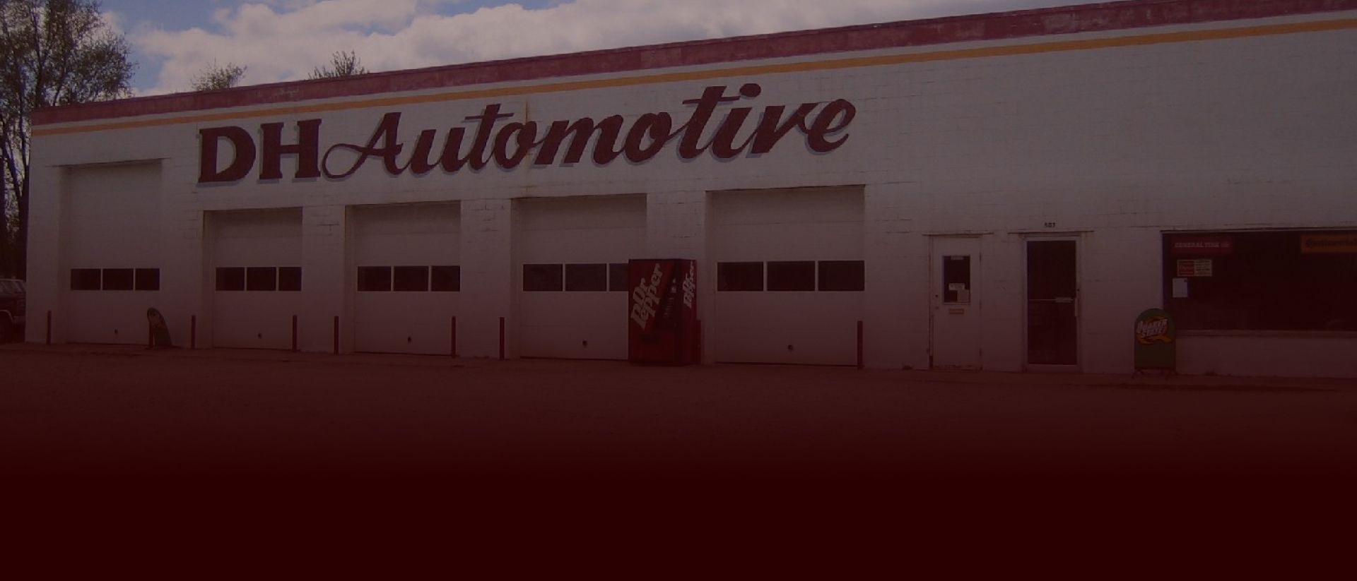 DH Automotive building with multiple garage doors. | DH Automotive