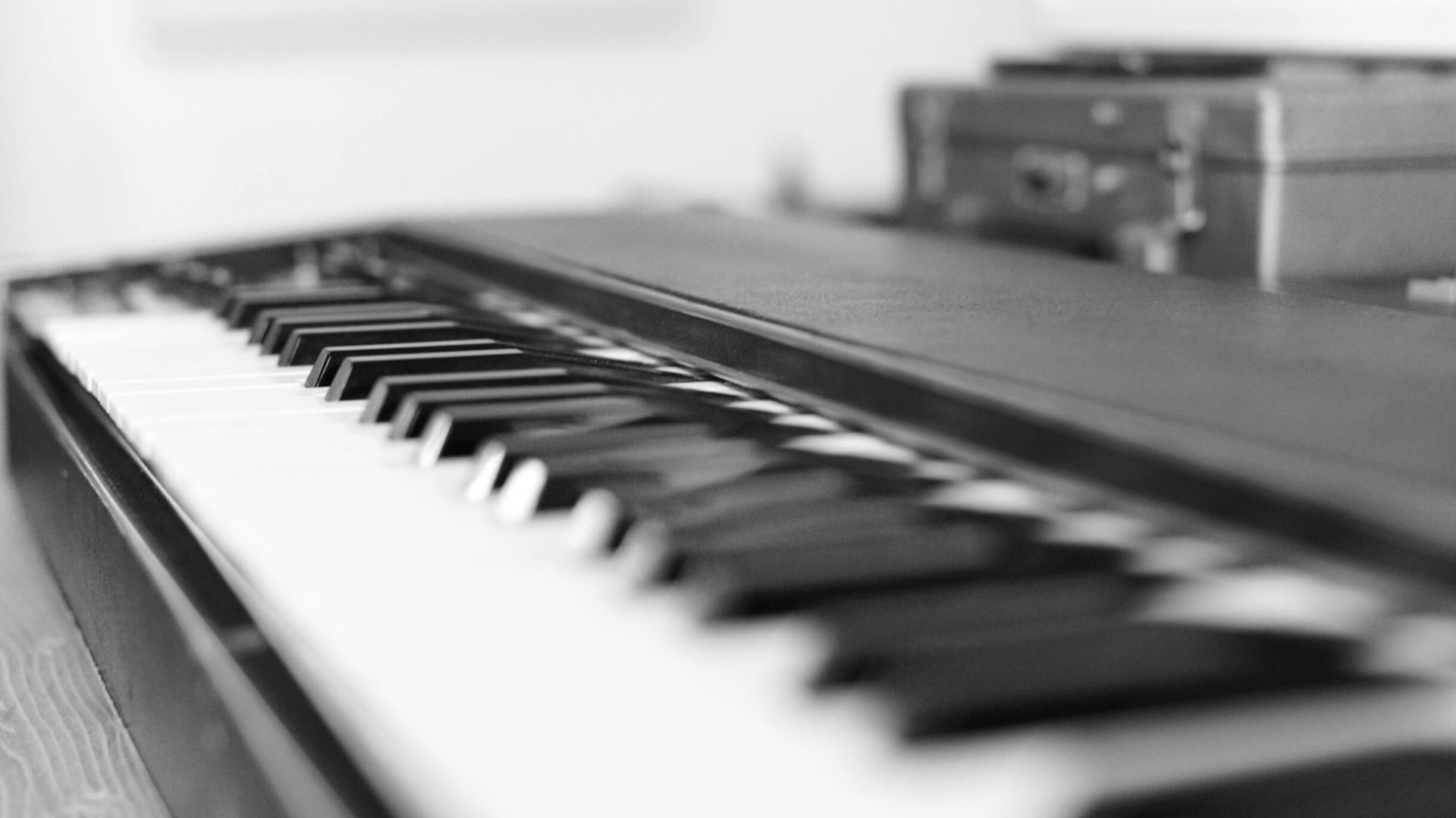 A black and white photo of a piano keyboard.