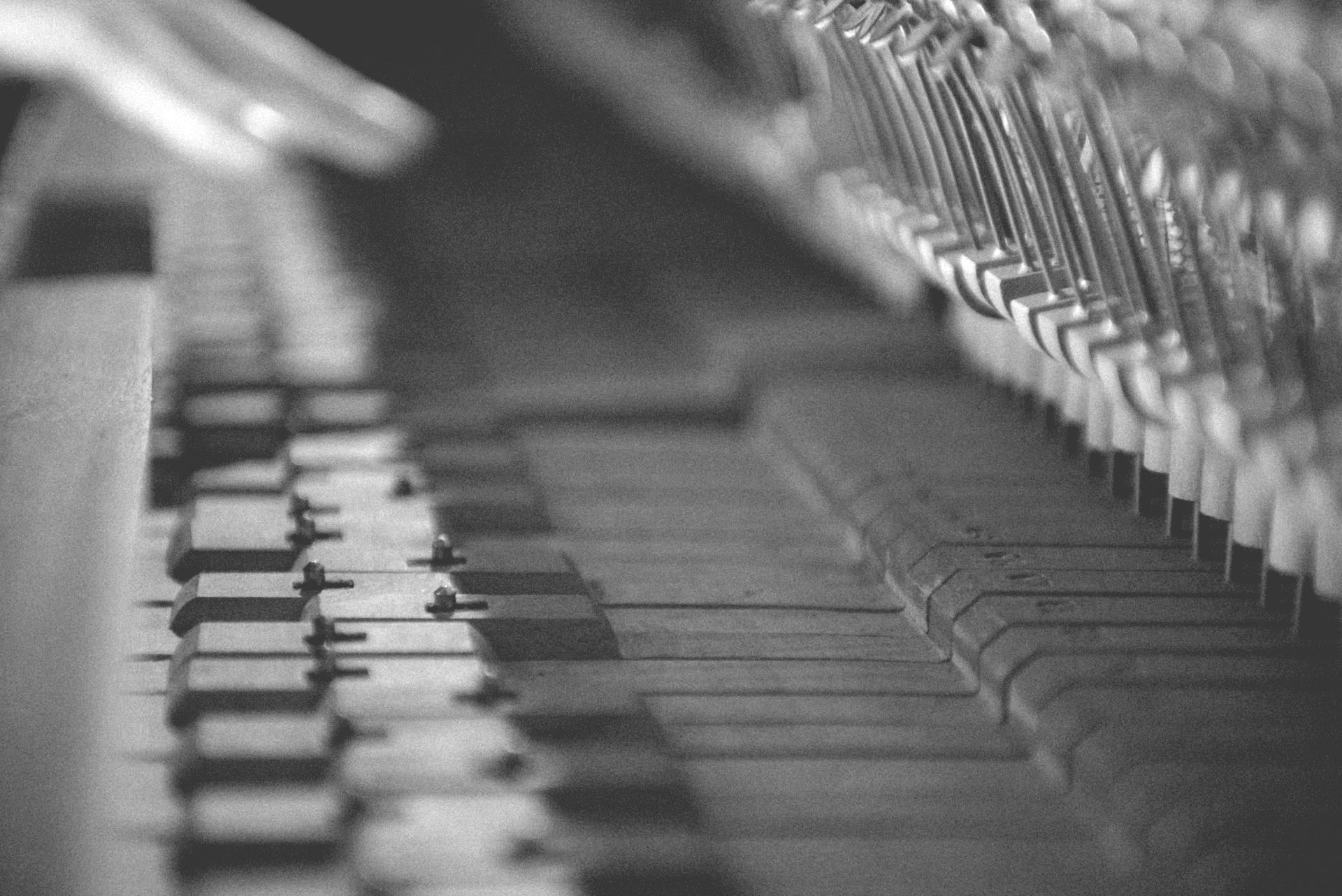 A black and white photo of a piano keyboard.