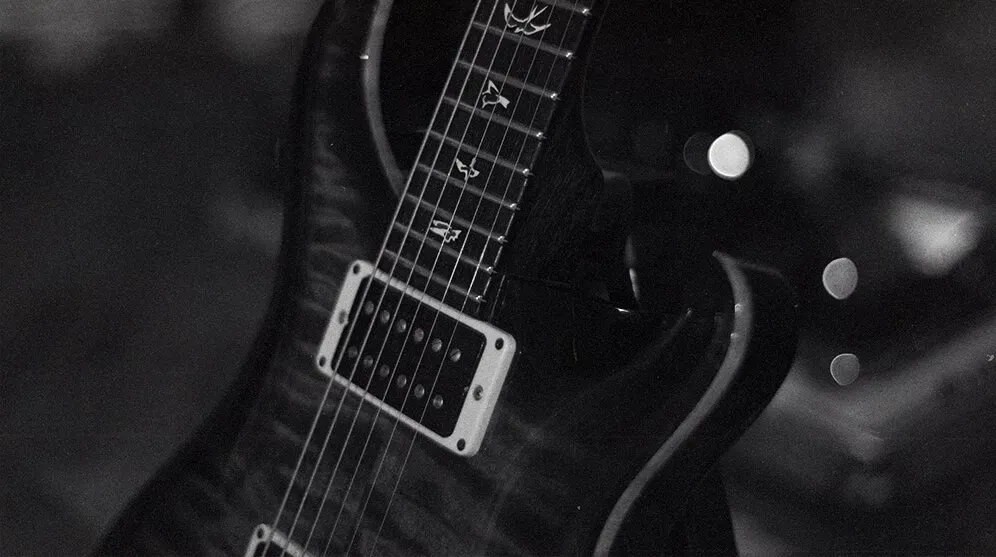 A black and white photo of an electric guitar