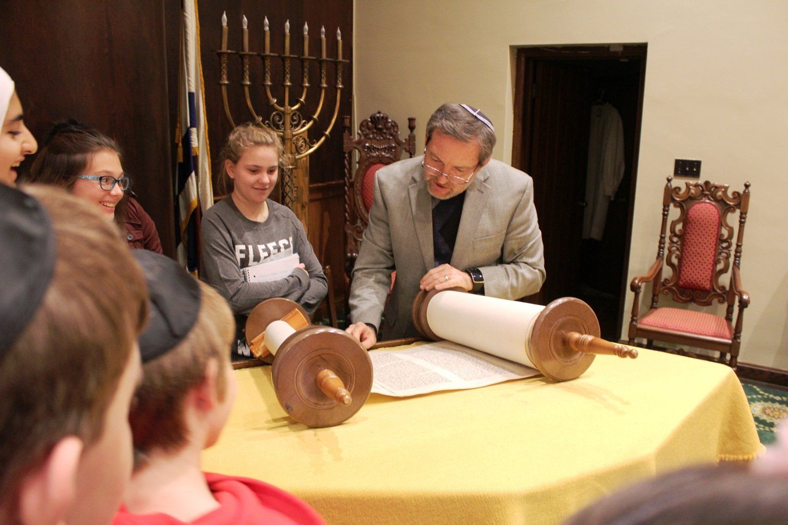 Guest teachers and artists in residence reading Torah