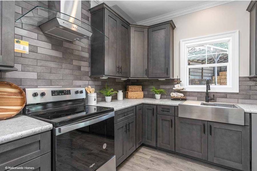 Modern kitchen with dark wood cabinetry, grey brick backsplash, stainless steel appliances, and a farmhouse sink.