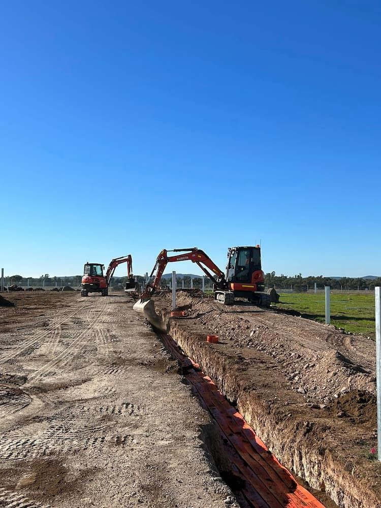 A Couple of Excavators Are Working on a Dirt Road — RL Hire In Geurie, NSW