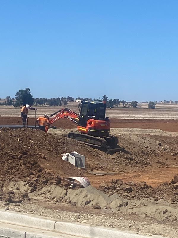 An Excavator is Moving Dirt on a Construction Site — RL Hire In Dubbo, NSW