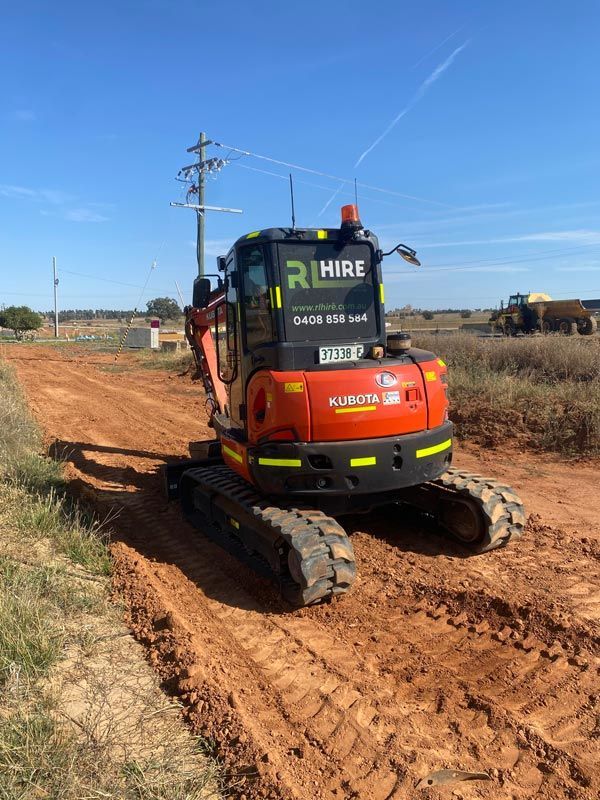 Excavator Hired Working on a Driveway — RL Hire In Dubbo, NSW
