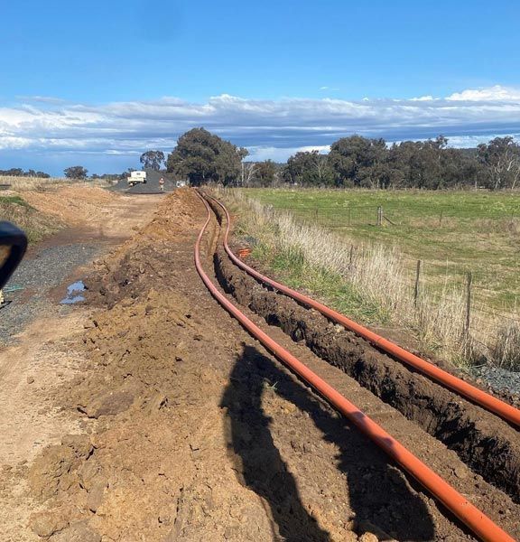 Long Orange Pipe for Underground Installation — RL Hire In Dubbo, NSW
