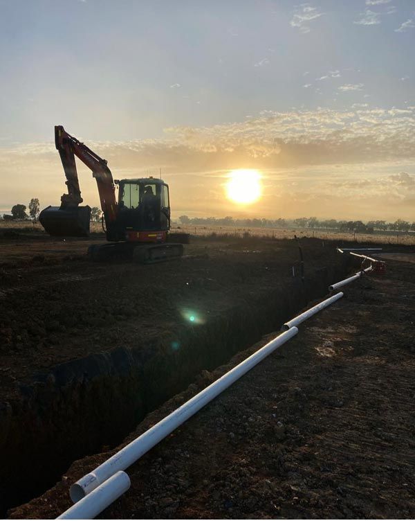 Long White Pipe and Excavator — RL Hire In Dubbo, NSW