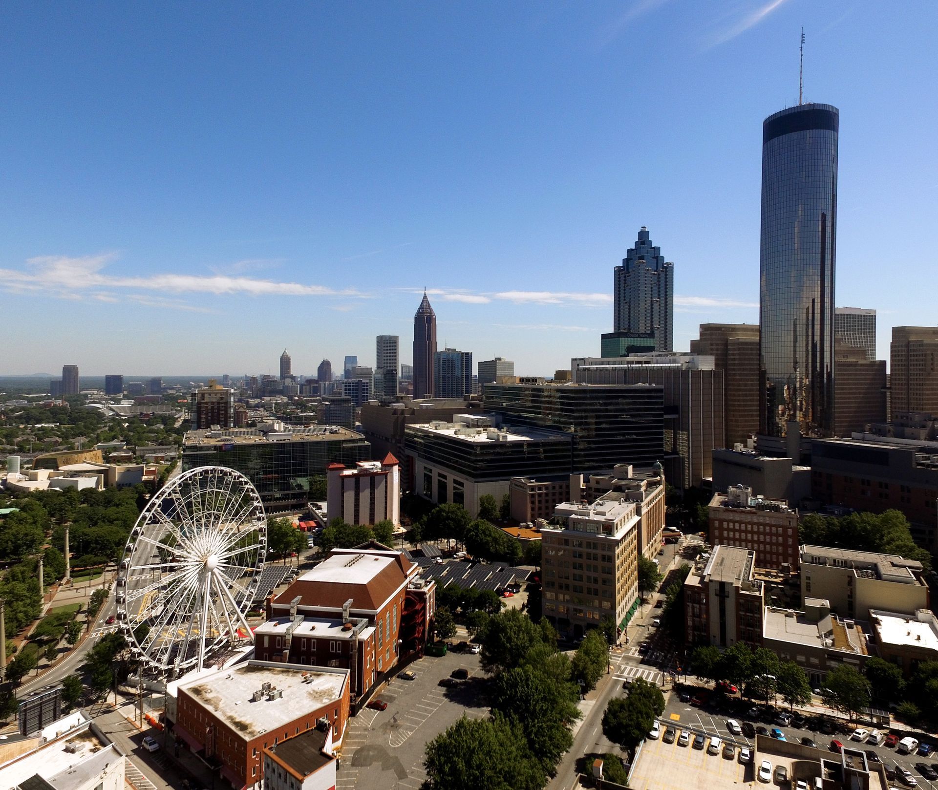 Atlanta skyline with Ferris wheel and blue sky.