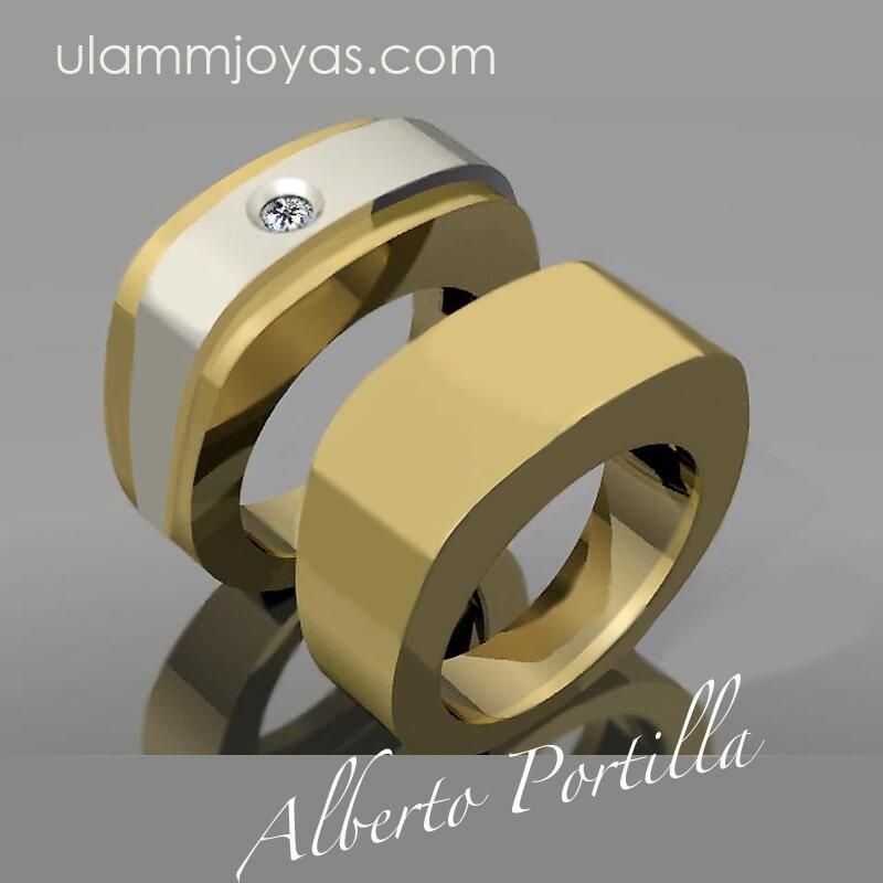 Un par de anillos de oro con el nombre de alberto portilla en la parte inferior