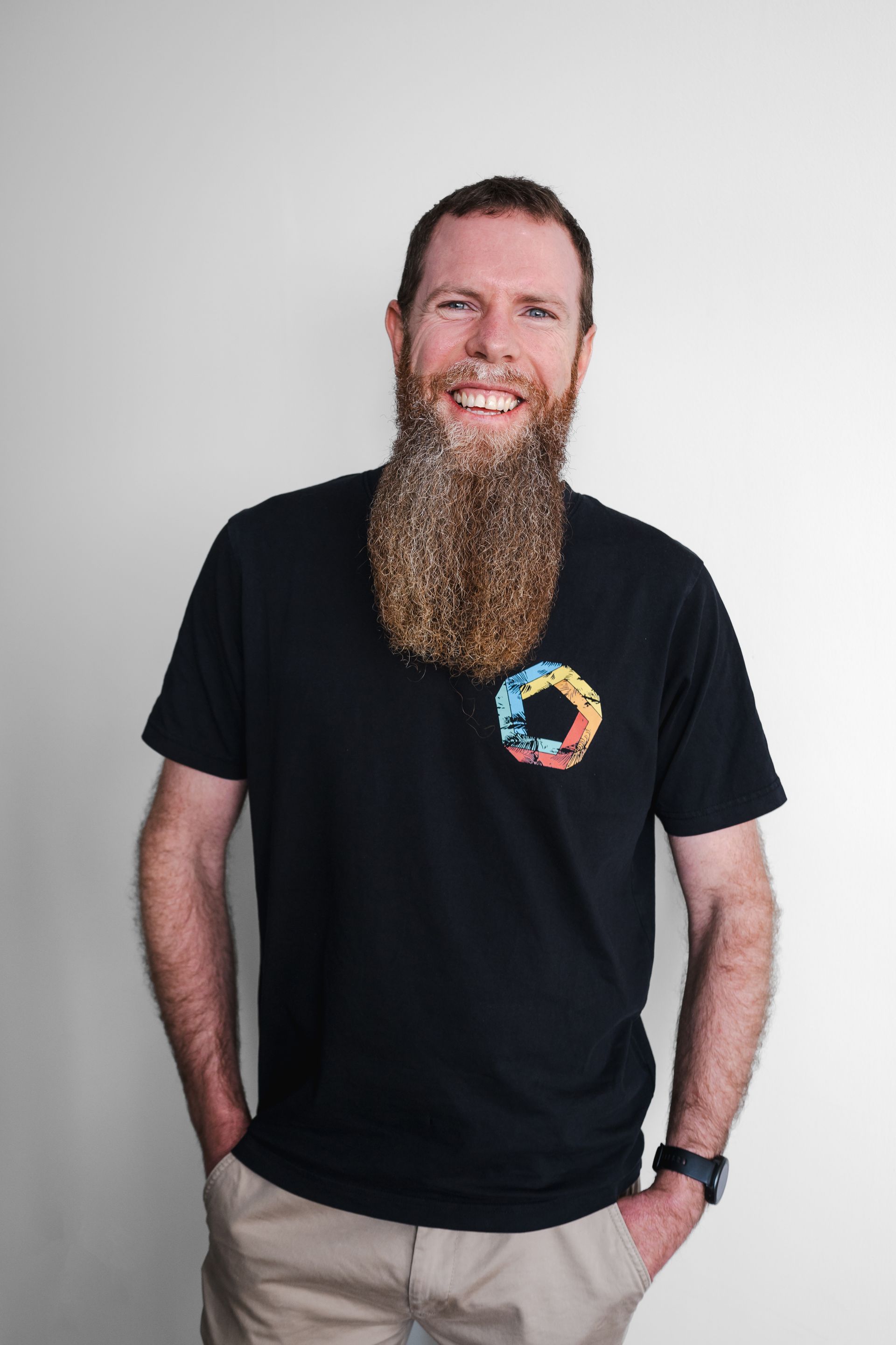 A man with a beard is wearing a black shirt