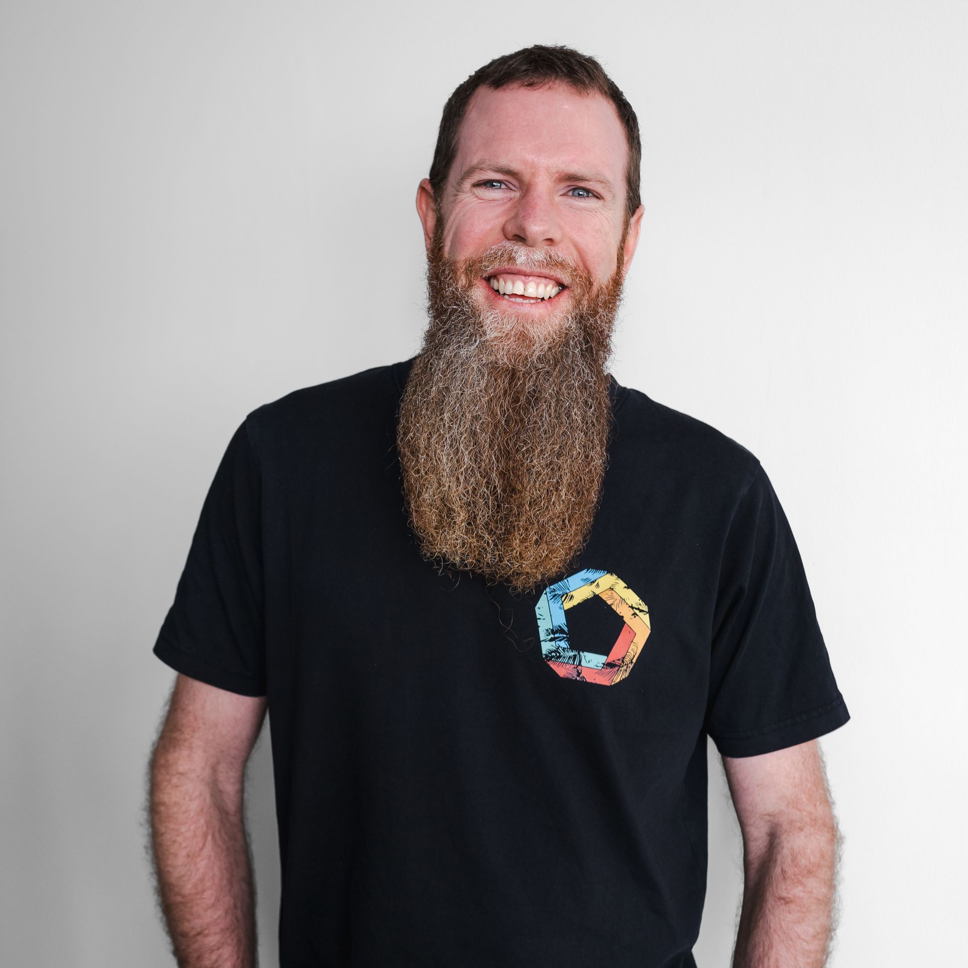 A man with a long beard is wearing a black shirt