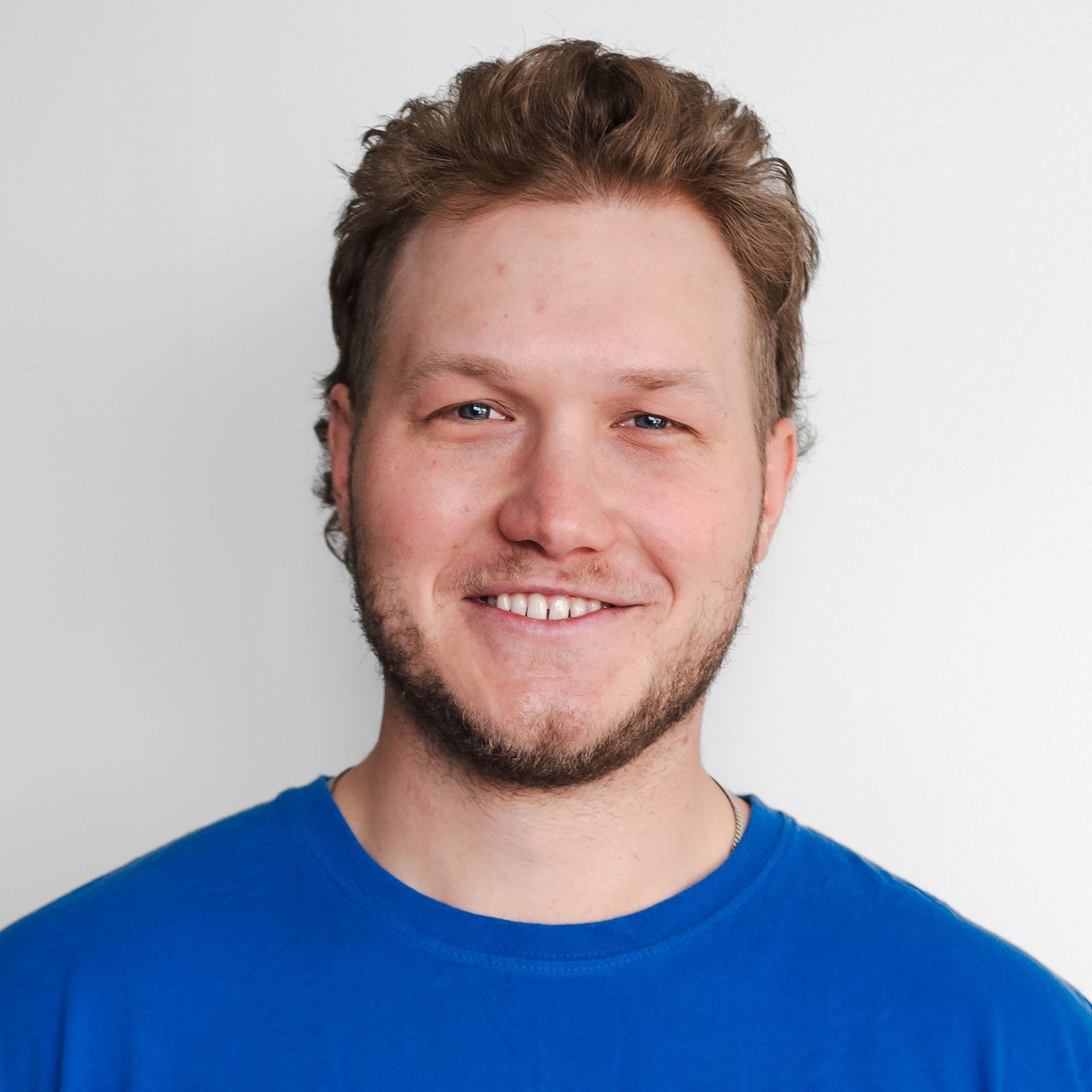 Wade Walsh is wearing a blue shirt and smiling