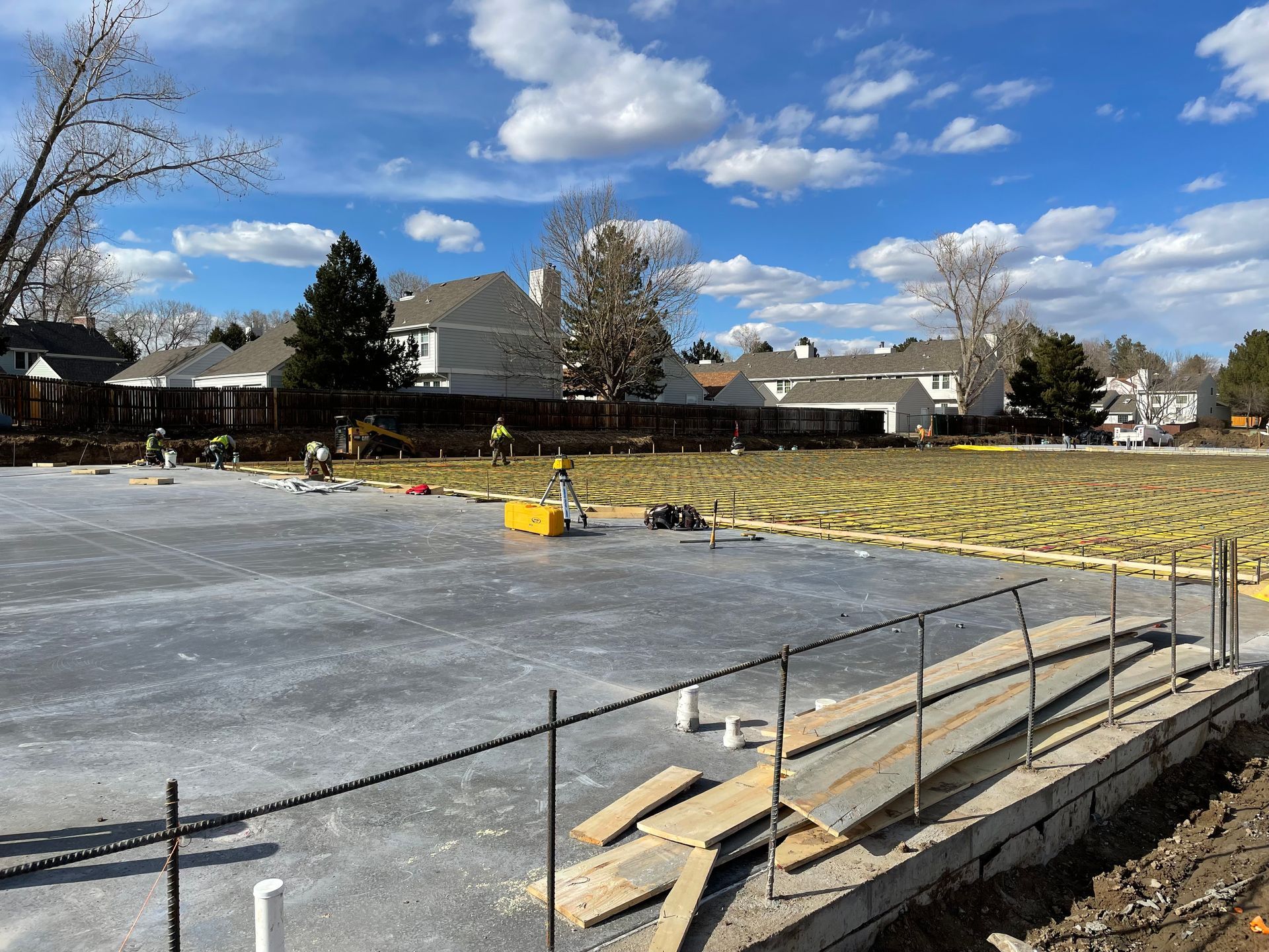A concrete foundation is being built in a residential area.