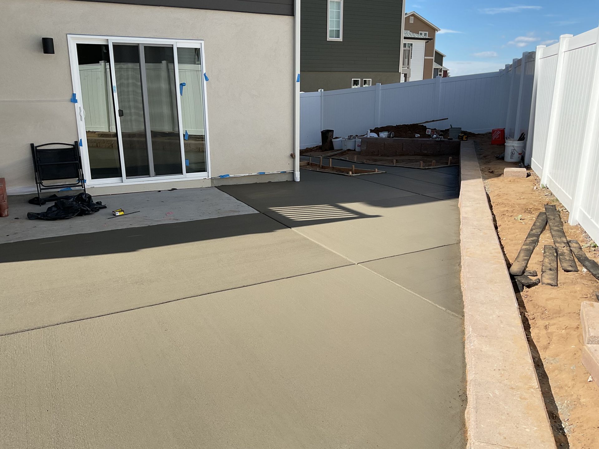 A white house with a table and chairs in front of it