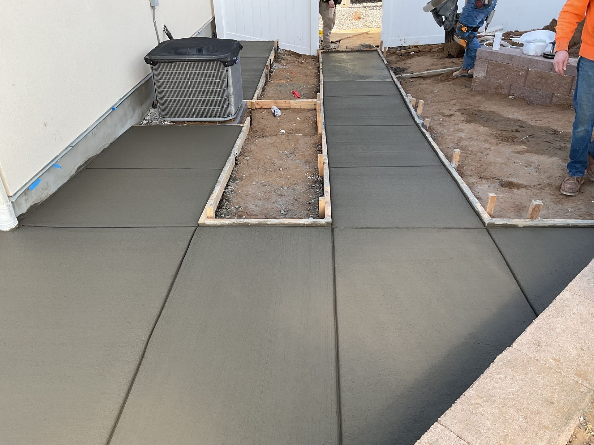 A concrete foundation is being built in a residential area.