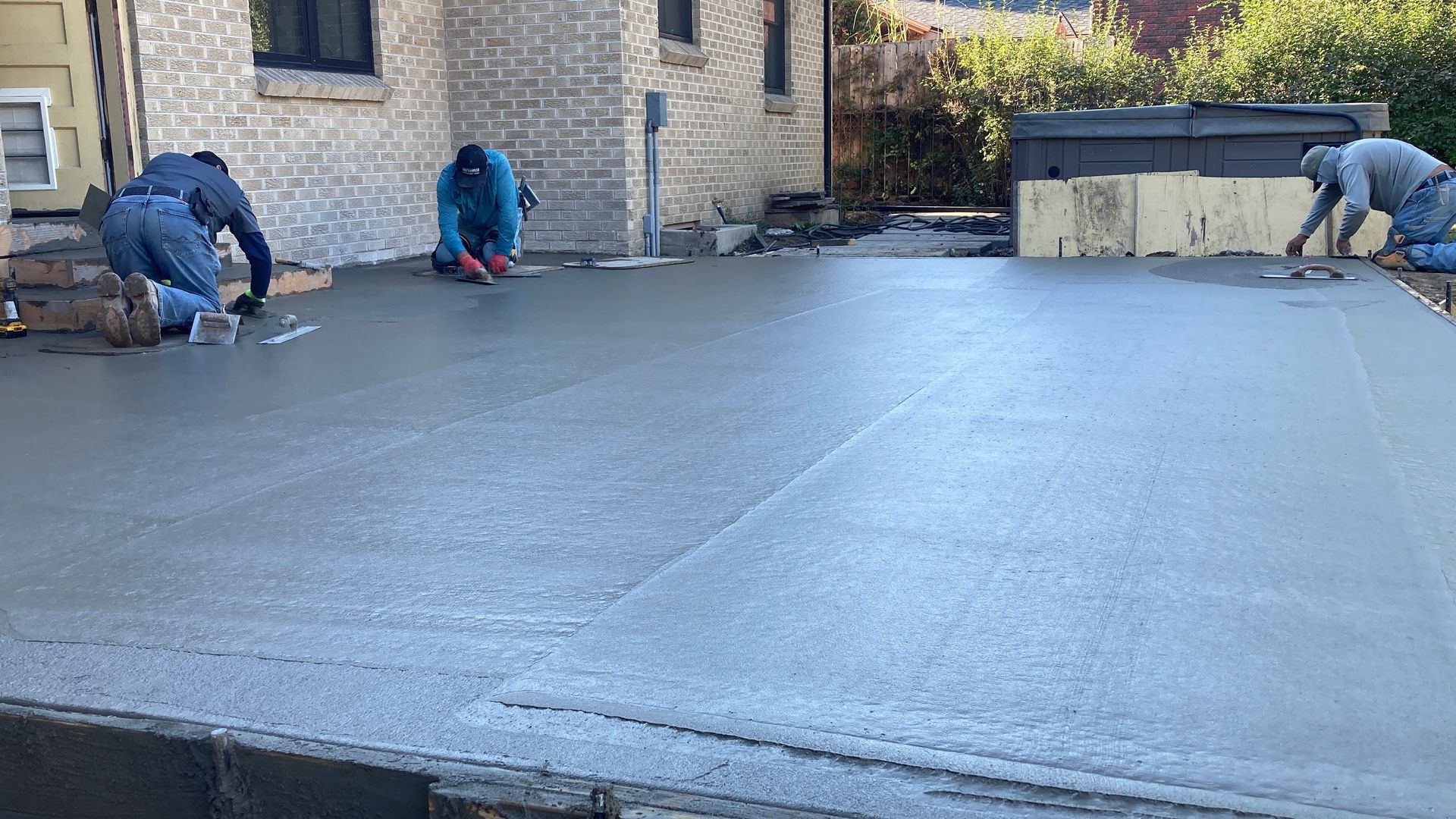 A red car is parked in front of a modern house.