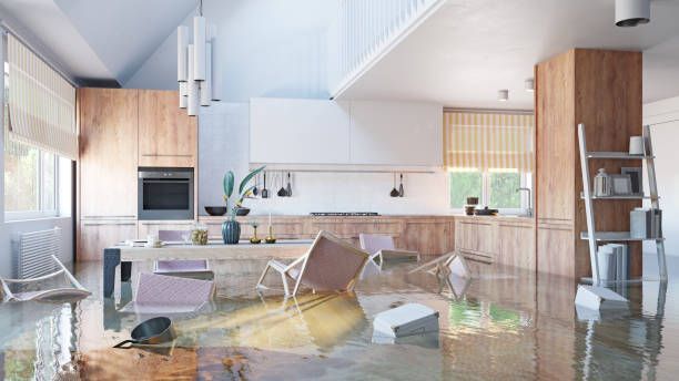 A kitchen and dining room submerged in water, highlighting the extent of flood damage restoration efforts needed.