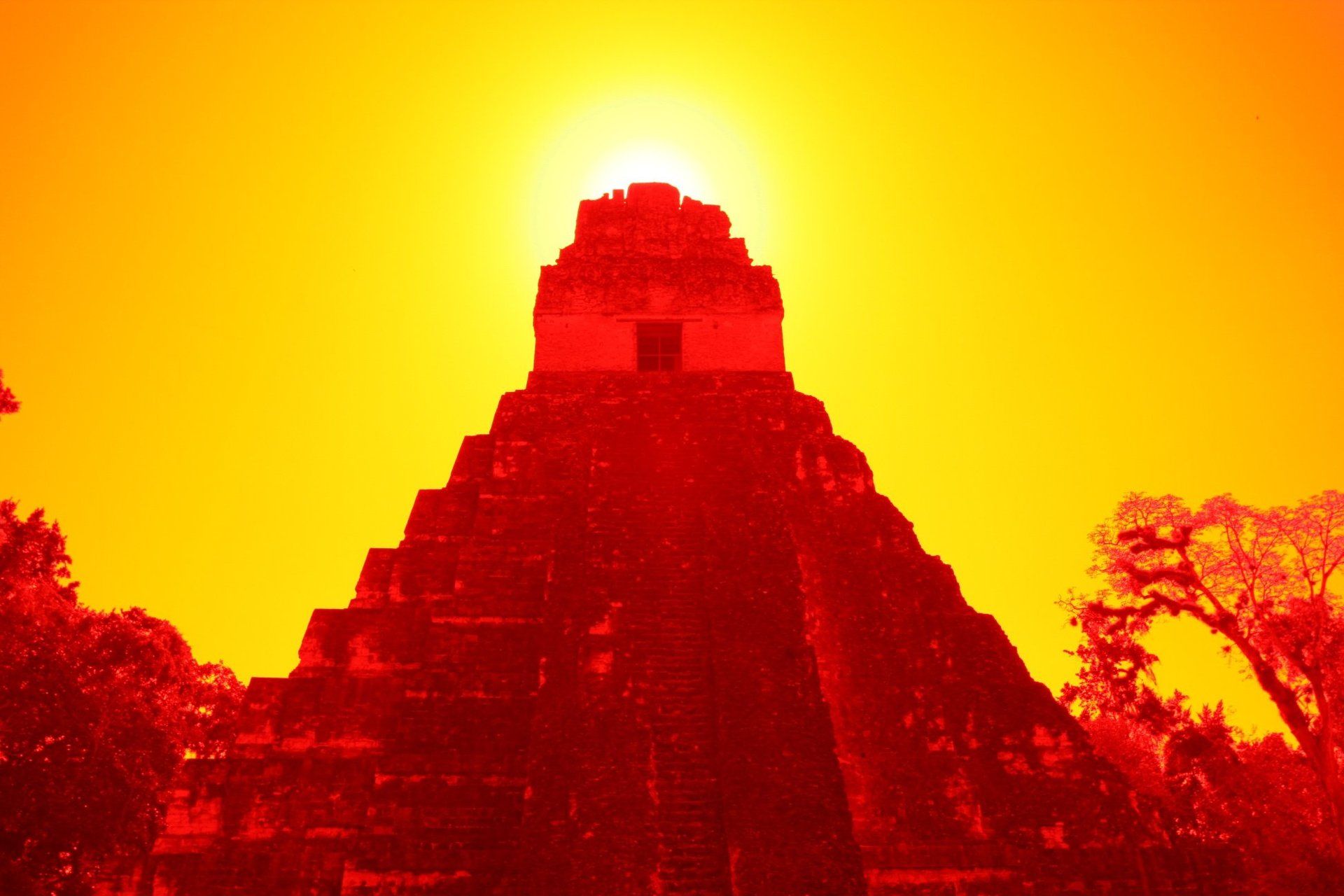 Die Sonne geht hinter einer Pyramide im Dschungel unter.