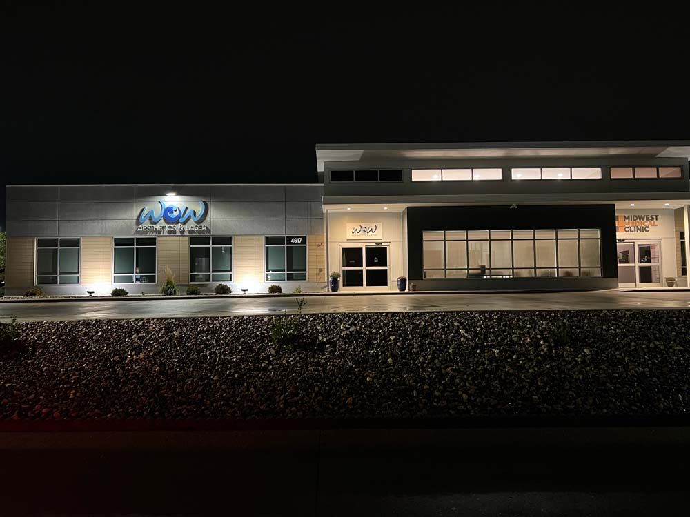 A large building is lit up at night and has the word new on it.