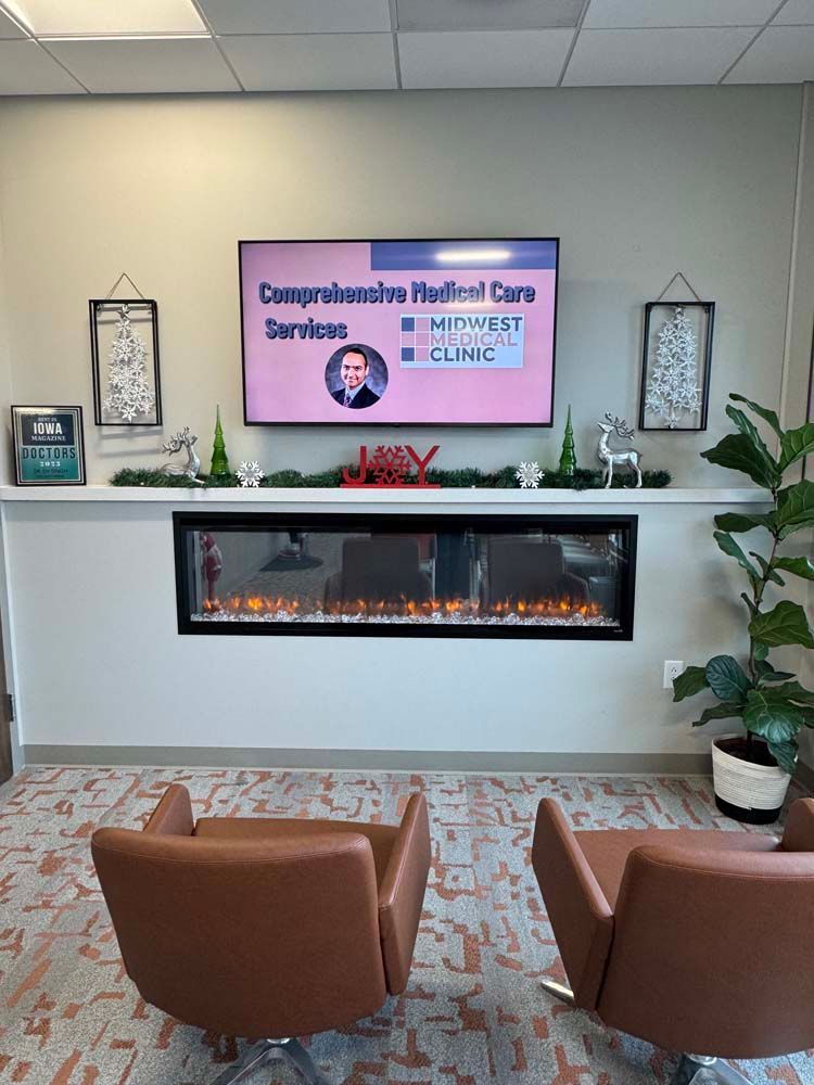 A living room with two chairs , a fireplace and a flat screen tv.