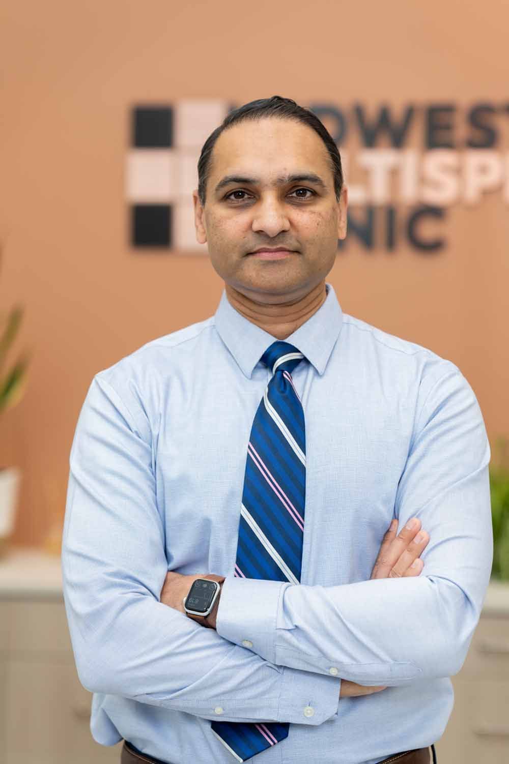 A man in a suit and tie is smiling for the camera.