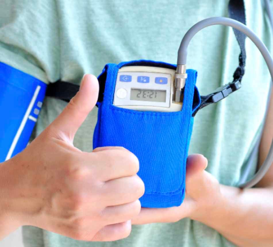 A person is holding a device that says 12:21 on it