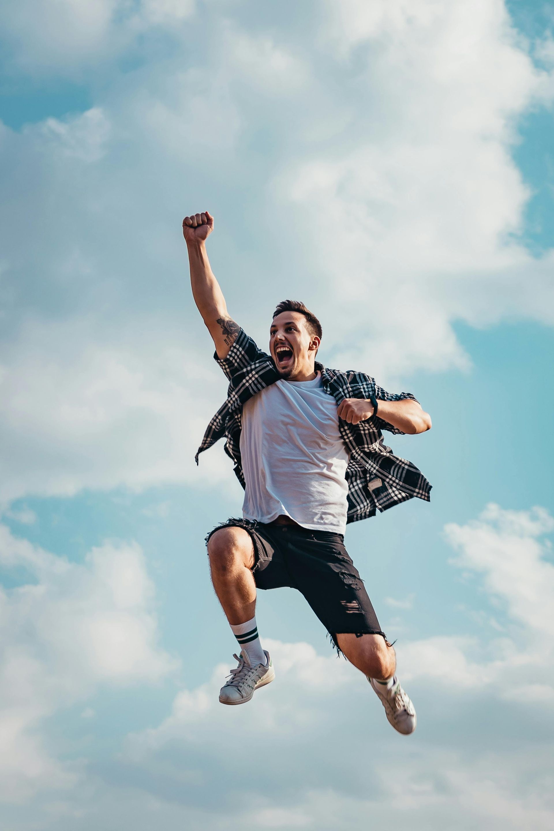 A man is jumping in the air with his fist in the air.