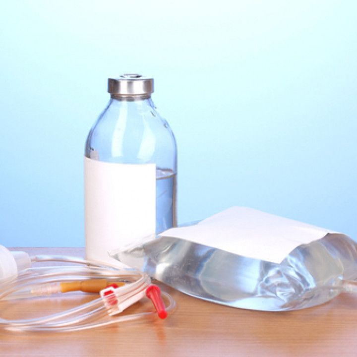 A bottle of water and a bag of water are on a table.