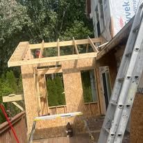 A ladder is sitting on top of a wooden structure.