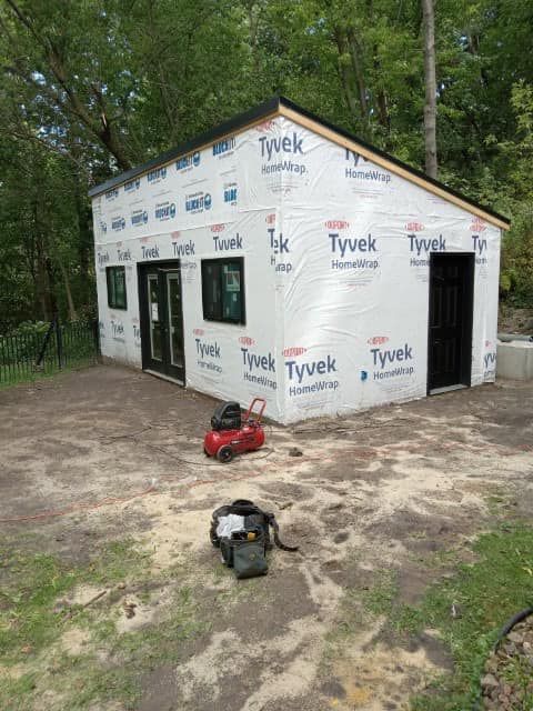 A small house is being built in a backyard.