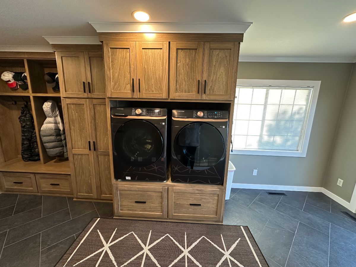 A laundry room with a washer and dryer stacked on top of each other.